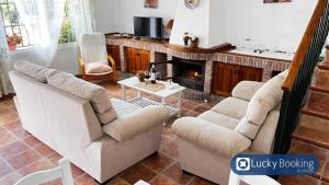 a living room with two couches and a fireplace at ZAHARA LUCKY BOOKING in Zahara de los Atunes