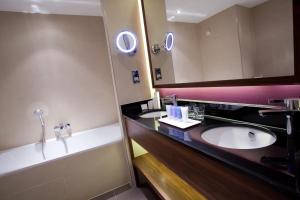 a bathroom with two sinks and a mirror at The Mere Golf Resort & Spa in Knutsford