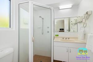 a bathroom with a shower and a sink at Island View Motel in Townsville