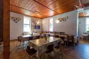 a dining room with tables and chairs in a building at Cabana Valea Stanciului in Răchiţele