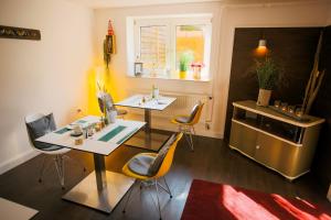 a kitchen with a table and chairs and a stove at Pension Mai-Scholle in Borkum