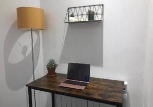 a laptop computer sitting on top of a wooden table at Doncaster City Centre Deluxe Whole Apartment sleeps 4 D2 in Doncaster