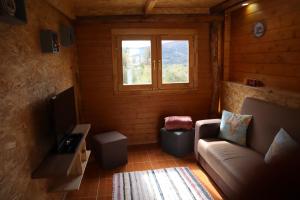 a living room with a couch and a window at Casinha do Canto in Góis