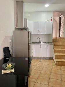 a kitchen with a refrigerator and a table at APARTAMENTO ARACENA RURAL in Aracena