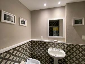 La salle de bains est pourvue d'un lavabo et d'un miroir. dans l'établissement Posada Güemes BOUTIQUE, à Mar del Plata