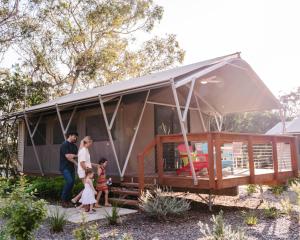 a family standing in front of a tiny house at Port Stephens Koala Sanctuary in One Mile