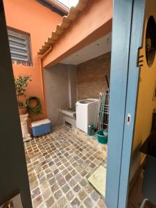 a kitchen with a tiled floor and a refrigerator at Hostel El Caminito LGBTQIAPN plus in Santos