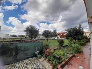 a view of a garden from a window at Mary's House in Cantanhede