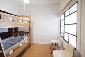Postel nebo postele na pokoji v ubytování Nikko Guesthouse Sumica