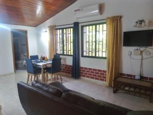 a living room with a couch and a table at Hostal Green Bay in San Andrés