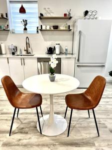 a white table and two chairs in a kitchen at Luxury and cozy 1 Bed Condo in the heart of Providence in Providence
