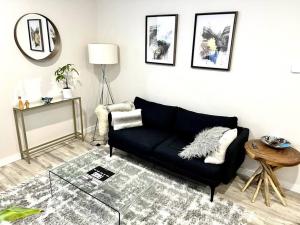 a living room with a black couch and a table at Luxury and cozy 1 Bed Condo in the heart of Providence in Providence