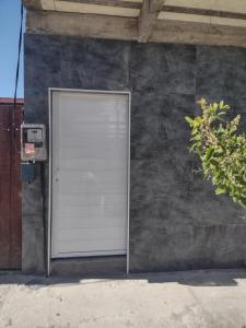 een witte deur aan de zijkant van een gebouw bij Kitnet em Cabo Frio 02 in Cabo Frio
