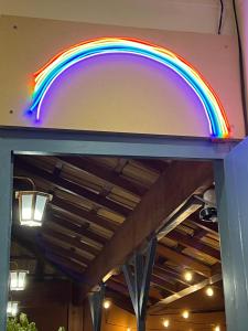 una señal de arco iris en el lateral de una gasolinera en Hostel El Caminito LGBTQIAPN plus en Santos