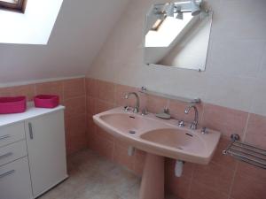a bathroom with a sink and a mirror at Holiday Home in Plouhinec with Sea Views in Plouhinec +17 photos
