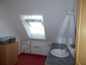 a bathroom with a sink and a skylight at Holiday Home in Doëlan with Sea View in Le Pouldu +17 photos
