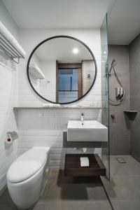a bathroom with a toilet and a sink and a mirror at Travelodge Kuala Lumpur City Centre in Kuala Lumpur +34 photos