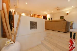 a living room with a couch and a table at Seascape Holidays Villa 8 Surya in Port Douglas +20 photos