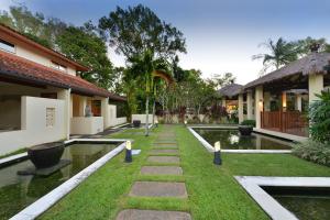 a courtyard of a house with a pond at Seascape Holidays Villa 8 Surya in Port Douglas