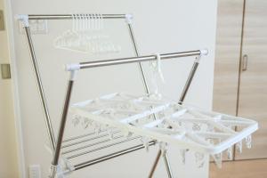 a metal drying rack in a kitchen with white appliances at PrimeRoom別府 Root in Beppu