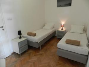 a room with two beds and two night stands at Apartment Mimosa in Kotor