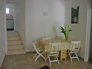 a dining room with a table and chairs at Apartment Mimosa in Kotor
