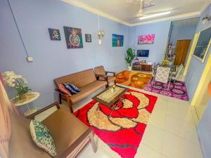 - un salon avec un canapé et une table dans l'établissement Nail Homestay Kuala Besut, à Kampung Kuala Besut