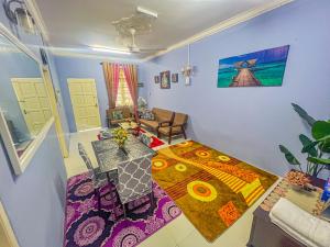 a living room with a table and a dining room at Nail Homestay Kuala Besut in Kuala Besut