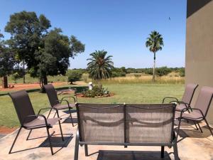 a group of chairs sitting on a patio at Ebenhaeser overnight accomodation in Bela-Bela