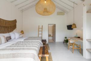 Postel nebo postele na pokoji v ubytování Jepun Sari Uluwatu
