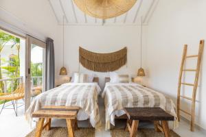 Postel nebo postele na pokoji v ubytování Jepun Sari Uluwatu