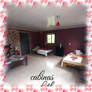 a room with two beds and a living room at cabins yafeth osa drake bay in Drake