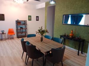 a dining room with a wooden table and chairs at Muslim Homestay at Meru Ipoh With Swimming Pool & Free Parkings in Ipoh