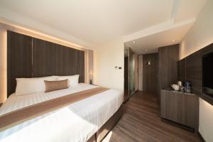 ein Schlafzimmer mit großem Bett und Fernseher in der Unterkunft Aspira Parc Sukhumvit 22 in Bangkok