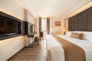 Ein Bett oder Betten in einem Zimmer der Unterkunft Aspira Parc Sukhumvit 22