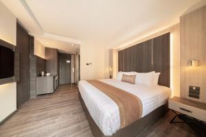 Ein Bett oder Betten in einem Zimmer der Unterkunft Aspira Parc Sukhumvit 22