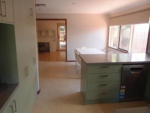 an empty room with a kitchen with a counter top at Corporate Share House in Melbourne