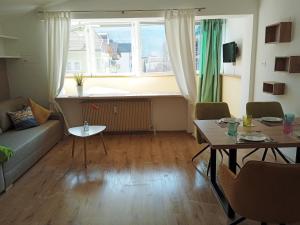 a living room with a couch and a table and a window at Apartment Himmelreich 29 in Plaus