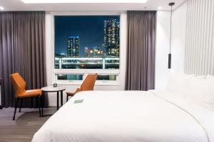 a hotel room with a view of a city skyline at AG405 Hotel in Busan