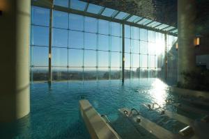 a large glass building with a tub in the water at Delpino in Sokcho