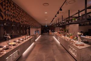 a restaurant with a long line of counters with food at Delpino in Sokcho +11 photos