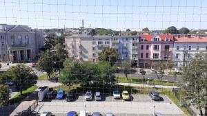 a city with cars parked in a parking lot at Apartament M-3 CENTRUM in Częstochowa