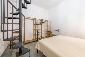 a room with a staircase next to a bed at Solemarevacanze Villasimius in Villasimius