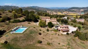 an aerial view of a villa with a swimming pool on a hill at Agriturismo Villalugnano in Lugnano