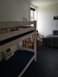 a bedroom with two bunk beds and a bed at Jelling Kro in Jelling