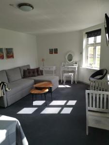 a living room with a couch and a table at Jelling Kro in Jelling