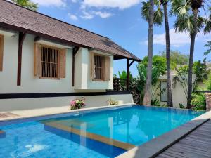 a villa with a swimming pool and a house at Villa Bukit Segara in Amed