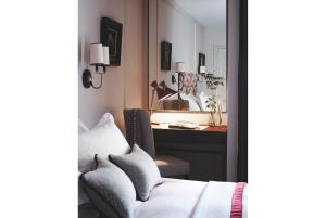 a bedroom with a desk and a bed and a mirror at Old Parsonage Hotel in Oxford