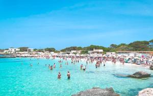 a group of people in the water at a beach at Stabilimento Lido Burrone in Favignana