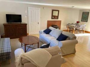a living room with a couch and a table at Cozy Cottage. Close to beach & woodland walks in Colinsburgh